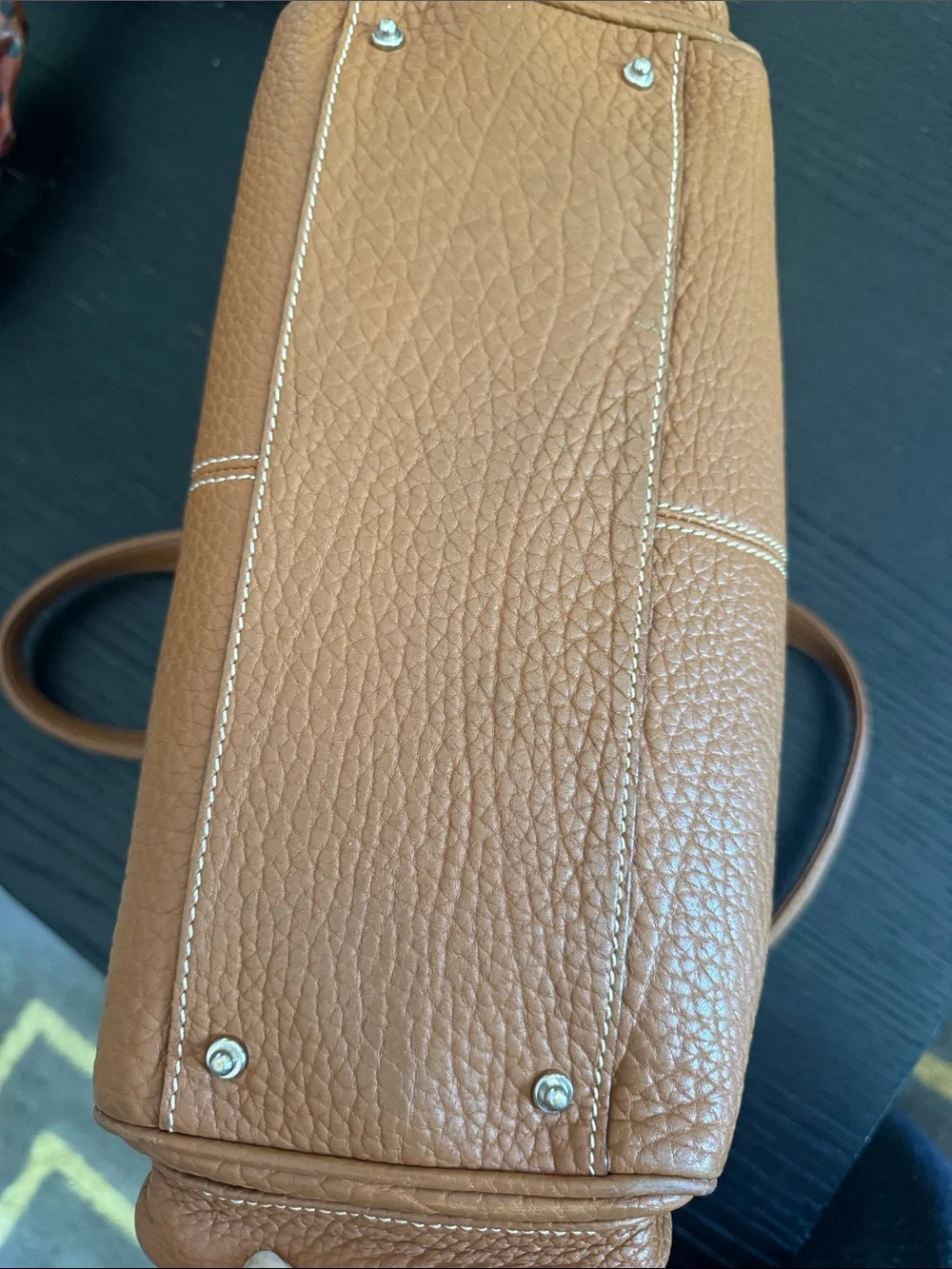 Dooney & Bourke tan pebbled leather side pockets belted satchel bag.